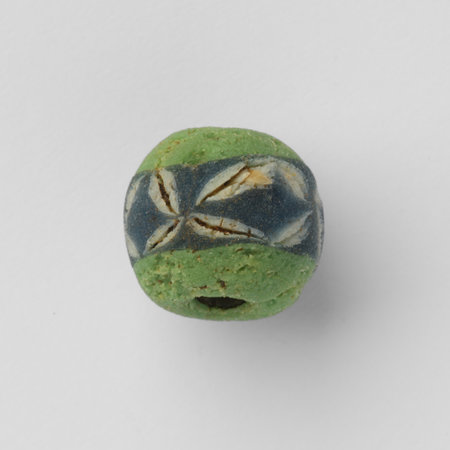 Ancient Roman glass bead with an ornamental band decorated with bunches of leavesの写真素材