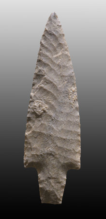 Neolithic flint dagger on black background