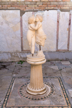 Statue of Cupido and Psyche kissing in Ostia Antica. Ruins of ancient roman city and port. Rome, Latium, Italyのeditorial素材