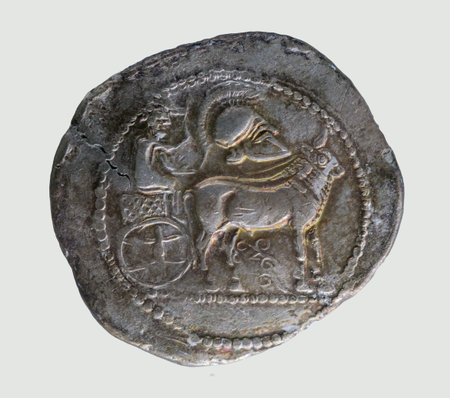 Dodekadrachm - Derrones (Thraco-macedonian region) - Male figure driving ox cart to right; above, crested Corinthian helmet to right and below, flower.の写真素材