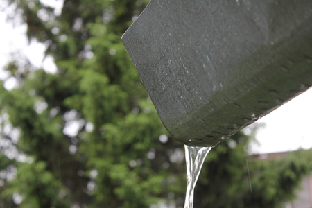 Rainwater runs down at the drain gutterの写真素材