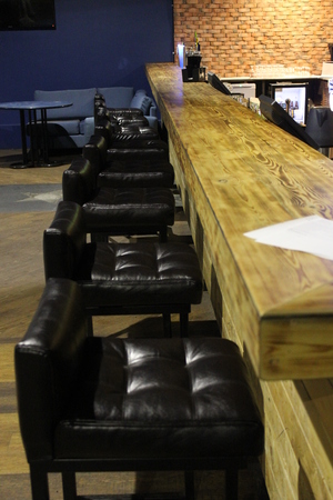 Black chairs near the wooden barの写真素材