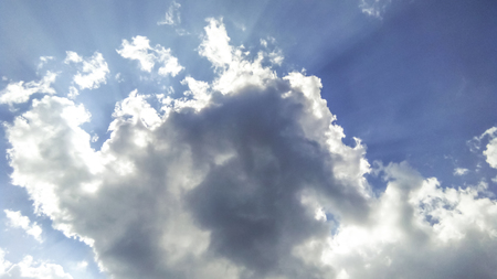 cumulus clouds like fluffy, white cotton balls on the blue sky. Beautiful in sunset, varying sizes and shapesの写真素材