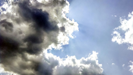 cumulus clouds like fluffy, white cotton balls on the blue sky. Beautiful in sunset, varying sizes and shapesの写真素材