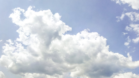 cumulus clouds like fluffy, white cotton balls on the blue sky. Beautiful in sunset, varying sizes and shapesの写真素材