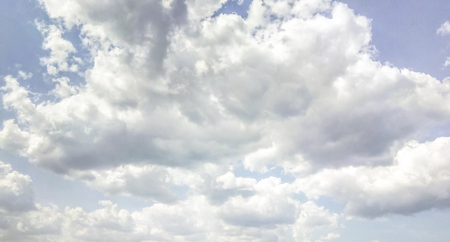 cumulus clouds like fluffy, white cotton balls on the blue sky. Beautiful in sunset, varying sizes and shapesの写真素材