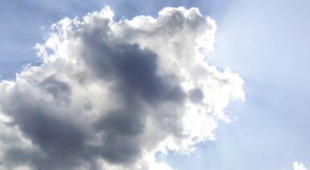 cumulus clouds like fluffy, white cotton balls on the blue sky. Beautiful in sunset, varying sizes and shapesの写真素材