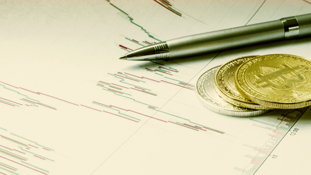 Gold and silver coin bitcoin, euro banknotes,stationery. Crypto currency course, schedule. Bitcoin is a modern way of exchange this crypto currency is a convenient means of payment in the financialの写真素材