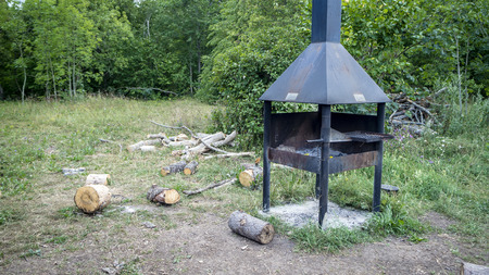 A great little picnic area in the forest with a grill and a fire ring plus its all under a nice shade summer houseの写真素材