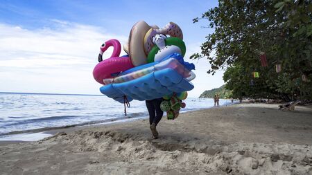 KOH CHANG, THAILAND - NOVEMBER 11, 2017: street vendor with Inflatable mattresses and toys is...