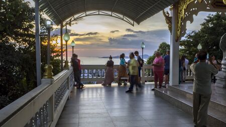 PATTAYA, THAILAND - NOVEMBER 21, 2017:  Aasian tourists and Panoramic view  from observation deck. long tower, different buildings and ocean in the background. Big Buddha Hill Sunset.のeditorial素材