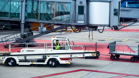 ANTALYA, TURKEY - JULY 25, 2018: wng of Turkish Airlines Airbus plane, Antalya international airport. Pushback tractor for moving luggage at the international airportのeditorial素材