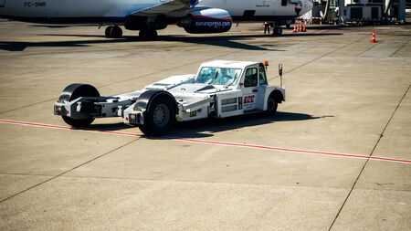 ANTALYA, TURKEY - JULY 25, 2018: wng of Turkish Airlines Airbus plane, Antalya international airport. Pushback tractor for moving luggage at the international airportのeditorial素材