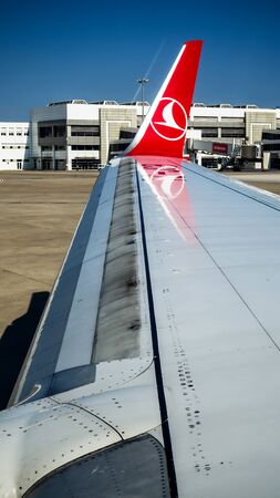 ANTALYA, TURKEY - JULY 25, 2018: wing of Turkish Airlines Airbus plane, Antalya international airport. The plane flies over the Mediterranean sea and the turkish coastline with the scenic cloudscape.のeditorial素材