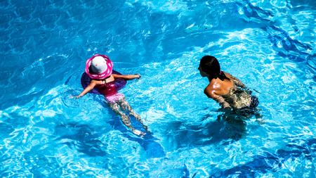swimming pool in a hotel in Turkey. concept of active holidays and travels.  Happy child and mother...