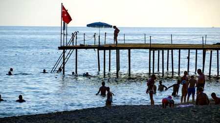 KONAKLI, ALANYA, TURKEY - 06 JULY 2018: tourists are relaxing and having fun on the beach of the Mediterranean Sea at the Titan hotelのeditorial素材