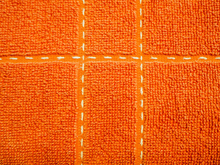 orange natural cotton towel background, closeup photo texture. Vintage white and blue towel texture - snow cover imitation for background or text box. Toweling materialの写真素材