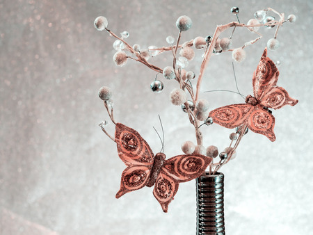Silver vase. Plant with pearls and golden butterflies. Christmas tree toys with blurred, sparkling background. Fir tree. New Year 2019. Lights, bokeh. festive. Merry Christmas concept. Copy spaceの写真素材