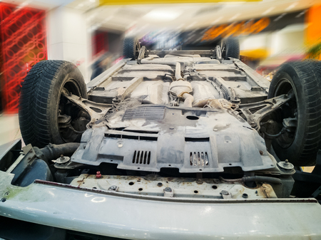 Car turned upside-down after road collision in Kristiine Shopping Centre. old  overturned car...
