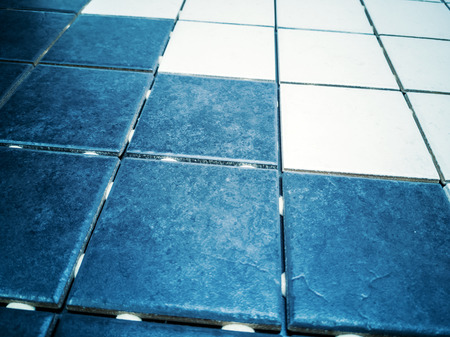 Installing of wall and floor dark blue and white tile. Ceramic glass colorful tiles mosaic composition pattern background -の写真素材