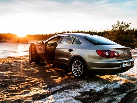 TALLINN, ESTONIA - JANUARY 22, 2017: Metallic Volkswagen Passat cc with opened door at the Manniku Lake. Sunny winter day, toned piture. Copy space for textbox. Image for wallpaper or backgroundのeditorial素材