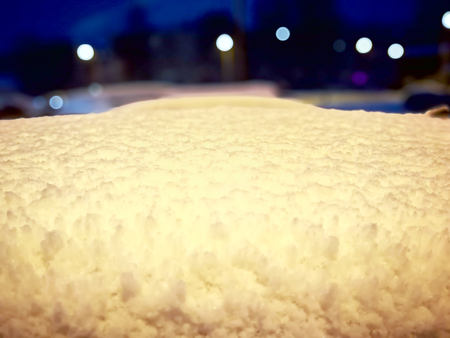Car buried under a snow after a blizzard during the night. Texture for design. Snowy white texture....