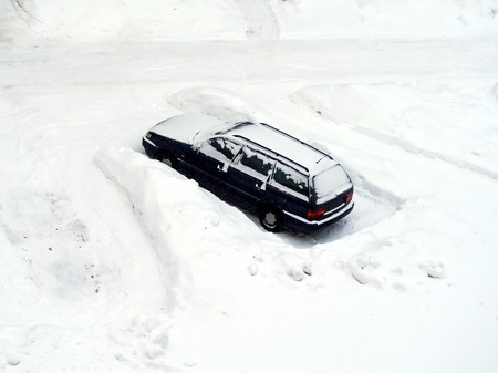 Ground parking cars after snowfall in winter, view from above, top or aerial view. Automobiles covered with snow, the traces of wheels and legs. Copy space for text box and design. White backgroundの写真素材