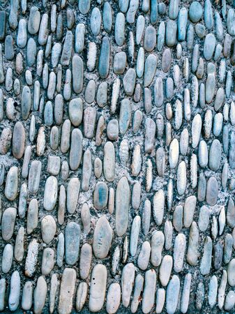 Pebble texture background. Colorful pebble stone texture on the road. Pavement of small stones. Little stones. Background texture. Used for laying asphaltの写真素材