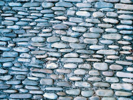 Pebble texture background. Colorful pebble stone texture on the road. Pavement of small stones. Little stones. Background texture. Used for laying asphaltの写真素材