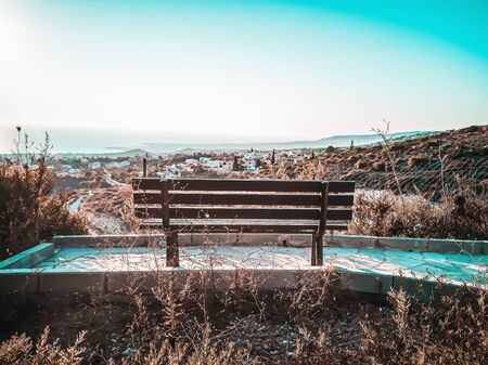 High view point wooden bench on cliff overlooking sea at sunset, Cyprus. Bench with view ocean...