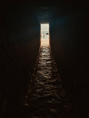 Light and exit in the end of dark long tunnel or corridor, way to freedom concept. Industrial round chalk mine passage With hole, perspective, tonedの写真素材
