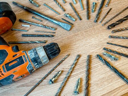 Power Tool on the wooden table. Selective Focus. Cordless screwdriver. Construction tool. Electric drill, close up of Drill set, Background and copy space. Electric cordless hand drill. maintenance home concept.の写真素材