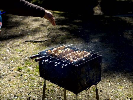 Red hot burning charcoal preparing for grilling, barbecue grill, BBQ. Forest on the background. Waiting for the placement of your food. Close up. vacation conceptの写真素材