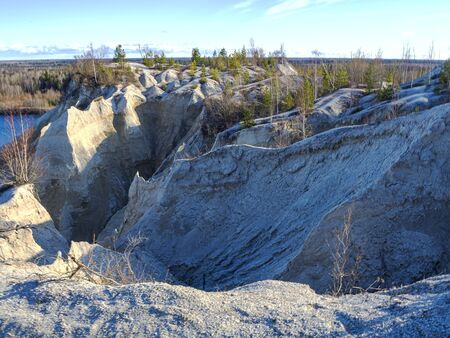 Abandoned Quarry Of Rummu, Estonia. Scenic View Of Land. Mountain of white sand and stones. Panoramic View. The erosion of limestone quarry. Sandy hill. Beautiful Texture of surface. Earth, explore.の写真素材