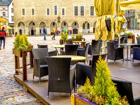 Street Cafe Tables spring Day in the City Street Sunshine Day in Old Town of Tallinn, Estonia. Table And Chairs On Street Cafe Terrace. copy spaceの写真素材