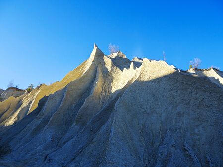 Abandoned Quarry Of Rummu, Estonia. Scenic View Of Land. Mountain of white sand and stones....