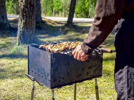 Red hot burning charcoal preparing for grilling, barbecue grill, BBQ. Forest on the background. Waiting for the placement of your food. Close up. vacation conceptの写真素材