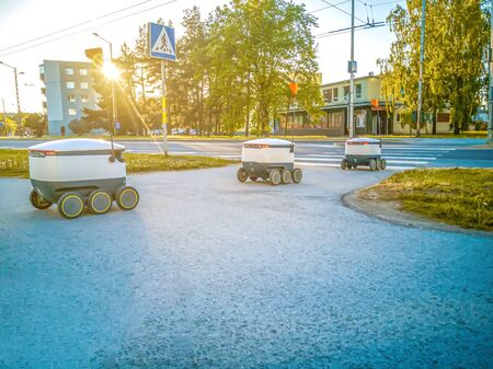 Some Delivery robots on the street. Estonian Cyber-couriers in Tallinn city. Sunny summer day. Copy space. Fitered image. the concept of new technology.の写真素材
