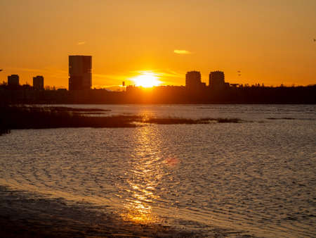 downtown buildings silhouettes. Nature Orange sea sunset in the city landscape beautiful landscape of Tallinn skyline Panoramic view on the beach. Estoniaの写真素材