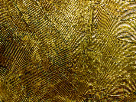 Metal Golden feather on black background. Gold glitter texture. Abstract painting. Art objectの写真素材