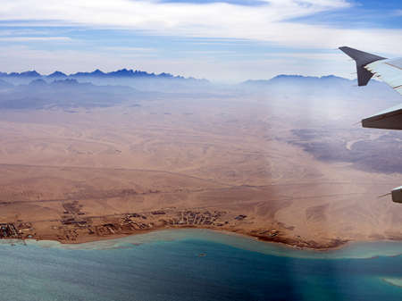 Aerial view above the clouds and sky, Inspiration concept. Travel freedom by air. Flight, view from the airplane to tropical sea with corals. Turbo-jet aircraft engine, transport 4k. Passenger airbusの写真素材