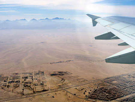 Aerial view above the clouds and sky, Inspiration concept. Travel freedom by air. Flight, view from the airplane to tropical sea with corals. Turbo-jet aircraft engine, transport 4k. Passenger airbusの写真素材