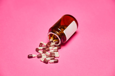 Pills with bottle on pink background.の写真素材