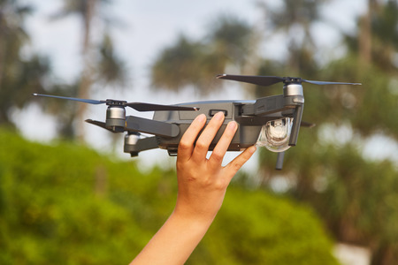 Drone in the female hand. Close-up. Sri Lanka. Girl launches drone.の写真素材