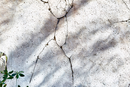 White old wall with cracked plaster. Background. Close up.