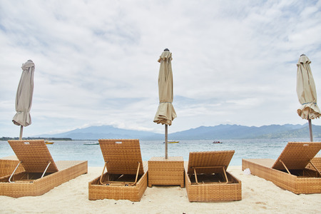 Sun beds with umbrellas on the Bali beach.の写真素材