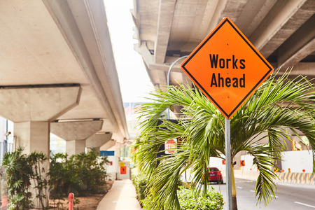 Red road sign "Works Ahead" close up.の写真素材