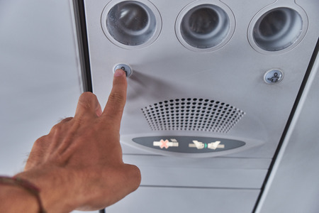 Flight attendant call button. Air conditioning in the plane.