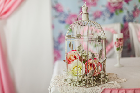 Pink flowers in a decorative white cage.の写真素材