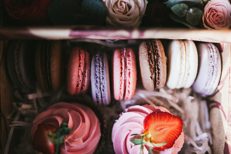 Handmade multicolored macarons and marshmallow close up.